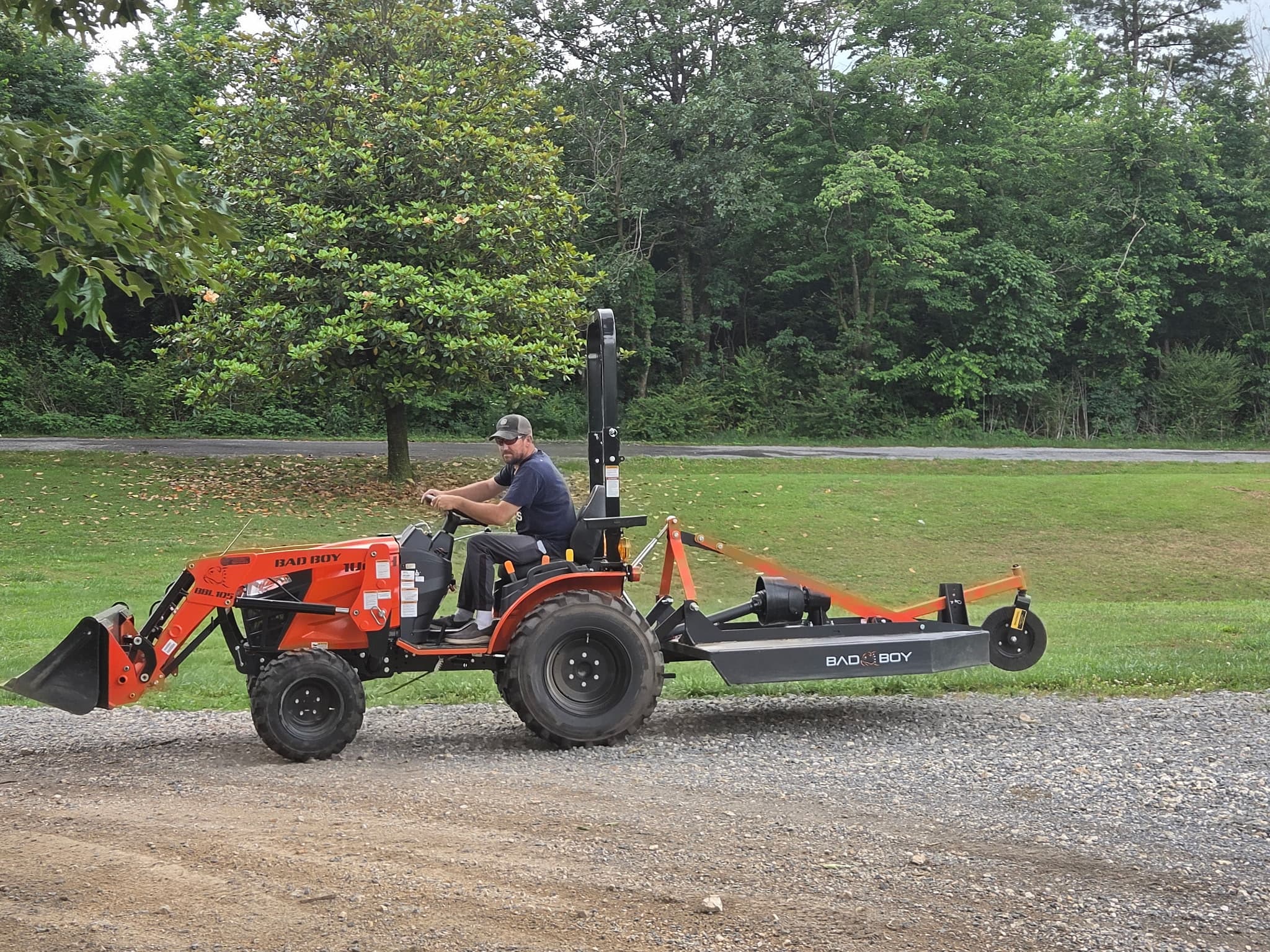 Roger Reed on a compact tractor with a rotary cutter, working a Henagar property